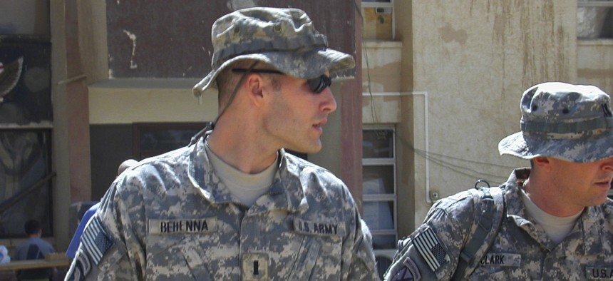 In this Sunday, Sept. 21, 2008, file photo, 1st Lt. Michael C. Behenna, left, and his defense attorney Capt. Tom Clark, right, walk in Camp Speicher, a large U.S. base near Tikrit, north of Baghdad, Iraq.