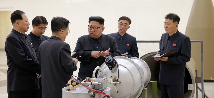 North Korean leader Kim Jong-un provides guidance with Ri Hong-sop (3rd L) and Hong Sung-mu (L) on a nuclear weapons program in this undated photo released by North Korea's Korean Central News Agency on September 3, 2017