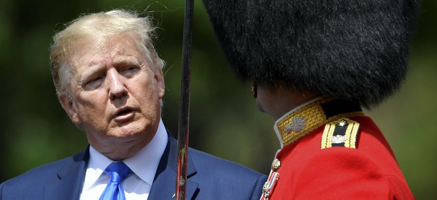 U.S. President Donald Trump inspects an honour guard during a welcome ceremony in the garden of Buckingham Palace, in London, for President Donald Trump and first lady Melania Trump Monday, June 3, 2019.