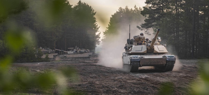 Soldiers aboard Army M1A2 Abrams tanks move out during an initial ready task force exercise at Johanna Range near Zagan, Poland, May 20, 2019.