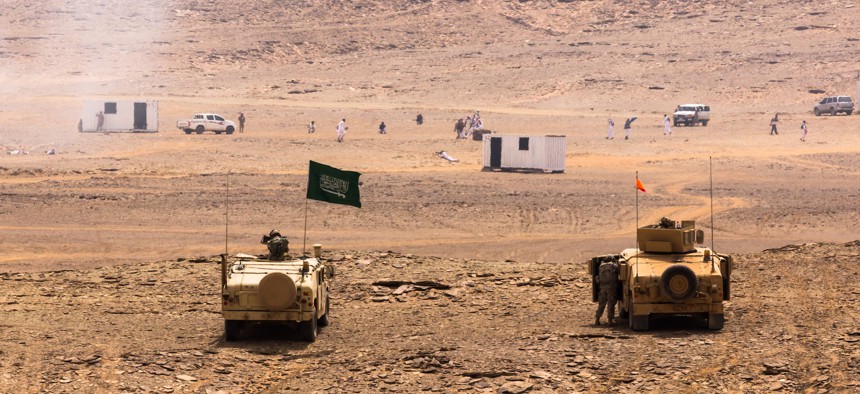 Royal Saudi Land Forces (RSLF) and U.S. Army soldiers from 4th Infantry Division assault a mock town after an  on April 13, 2014, near Tabuk, Saudi Arabia.