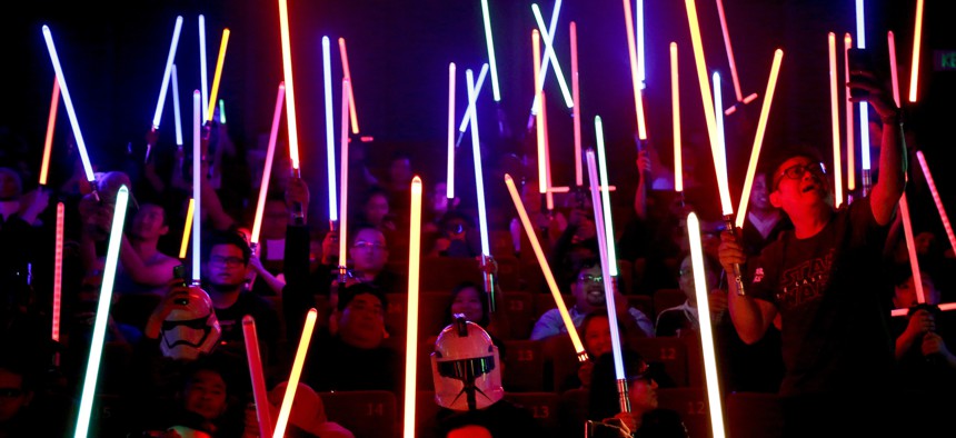 These aren't the Jedi you're looking for. Star Wars fans raise their lightsabers before the starts of "Star Wars: The Last Jedi" movie in Subang Jaya, Malaysia, Friday, Dec. 15, 2017