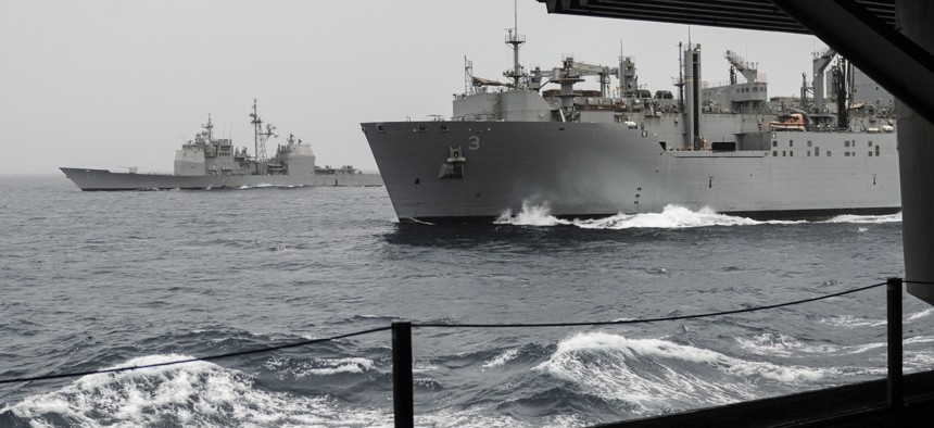 The guided-missile cruiser USS Princeton (CG 59), left, and the Military Sealift Command dry cargo ammunition ship USNS Alan Shepard (T-AKE 3) break away from the aircraft carrier USS Nimitz (CVN 68) after a replenishment-at-sea in 2013.