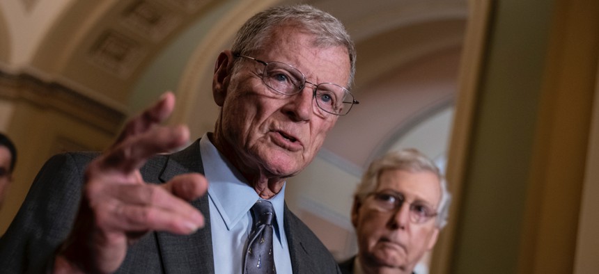 Senate Armed Services Committee Chairman Jim Inhofe, R-Okla., joined at right by Senate Majority Leader Mitch McConnell, R-Ky.