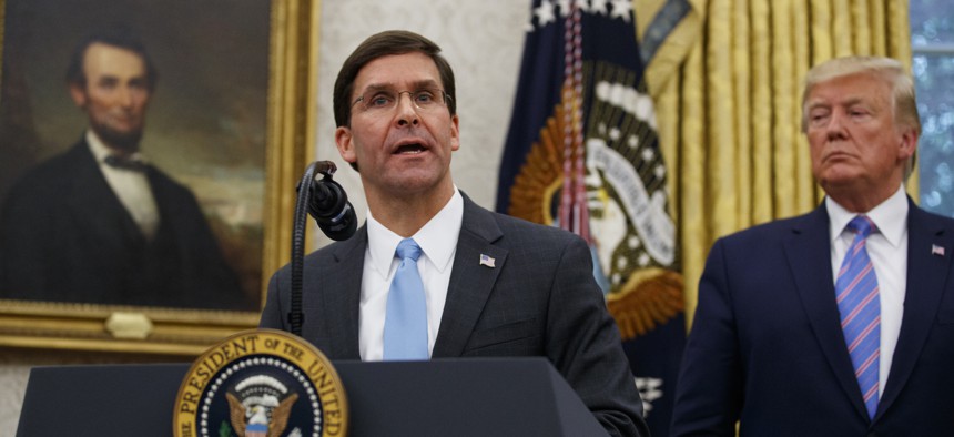 President Donald Trump looks to Secretary of Defense Mark Esper during a ceremony in the Oval Office at the White House in Washington, Tuesday, July 23, 2019.
