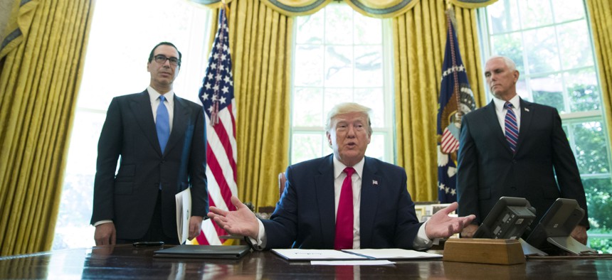 President Donald Trump after signing an executive order to increase sanctions on Iran, in the Oval Office, Mon., June 24, 2019, in Washington. Trump is accompanied by Treasury Secretary Steve Mnuchin, left, and Vice President Mike Pence. 