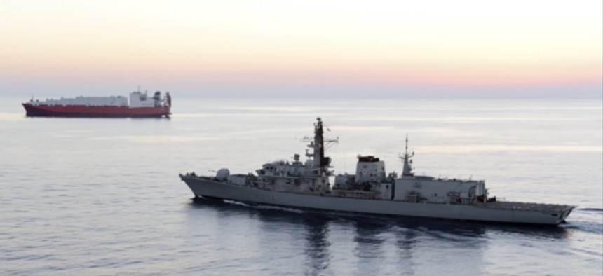 In this image from file video provided by UK Ministry of Defence, British navy vessel HMS Montrose escorts another ship during a mission to remove chemical weapons from Syria at sea off coast of Cyprus in February 2014.