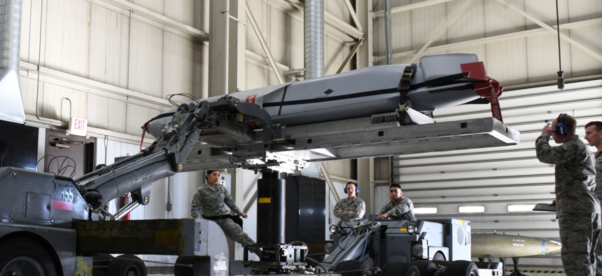 Load crew members from the 28th Munitions Squadron use a munitions lift truck or ‘jammer’, to load an inert AGM-158 Joint Air-to-Surface Standoff Missile into a simulated B-1 bomber.