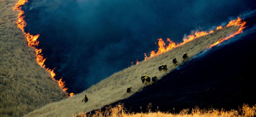 Firefighters battle the Marsh Fire near the town of Brentwood in Contra Costa County, Calif., Aug. 3.