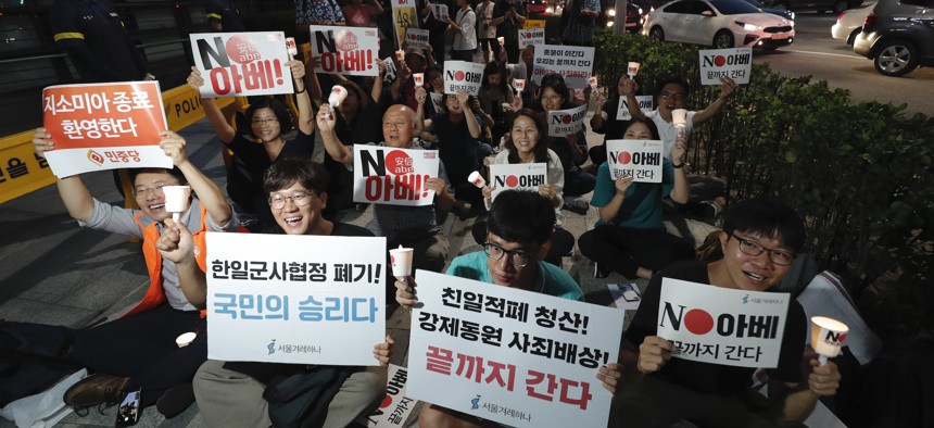 South Korean protesters react during a rally about the General Security of Military Information Agreement, or GSOMIA, in front of Japanese embassy in Seoul, South Korea, Thursday, Aug. 22, 2019.