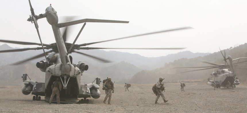 U.S. Marines exit CH-53E Super Stallion helicopters as part of the vertical assault raid portion of exercise Ssang Yong 2014 at Su Seong-Ri Range in Pohang, Republic of Korea, in 2014.