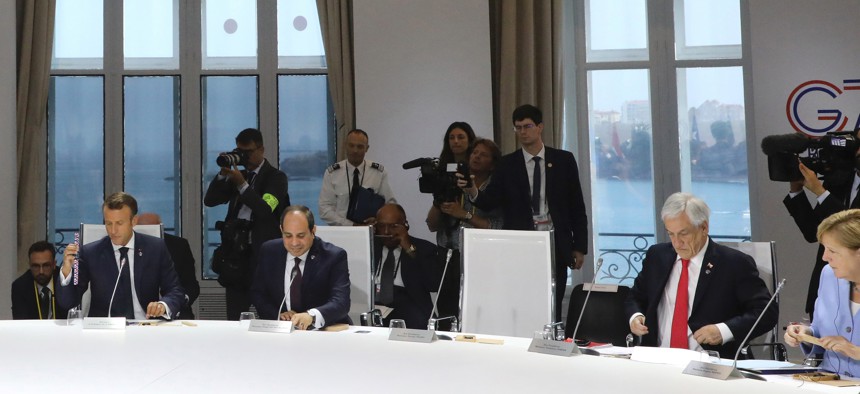 French, Egyptian, Chilean, and German leaders attend a work session on climate on the third day of the annual G7 Summit. The empty seat at third right was the place reserved for U.S. President Donald Trump. (Ludovic Marin, Pool via AP)