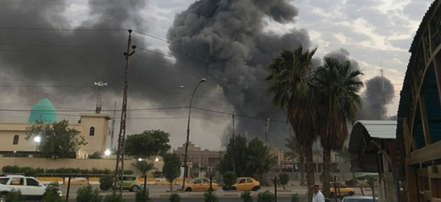  On Aug. 12, 2019, plumes of smoke rise after an explosion at a military base southwest of Baghdad, Iraq. 