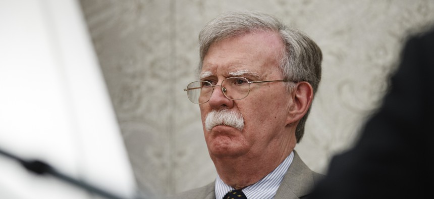 National security adviser John Bolton listens as President Donald Trump speaks during a meeting with Romanian President Klaus Iohannis in the Oval Office of the White House, Tuesday, Aug. 20, 2019, in Washington.