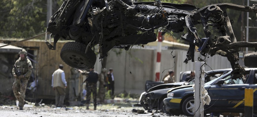 Resolute Support (RS) forces remove a destroyed vehicle after a car bomb explosion in Kabul, Afghanistan, Thursday, Sept. 5, 2019. 