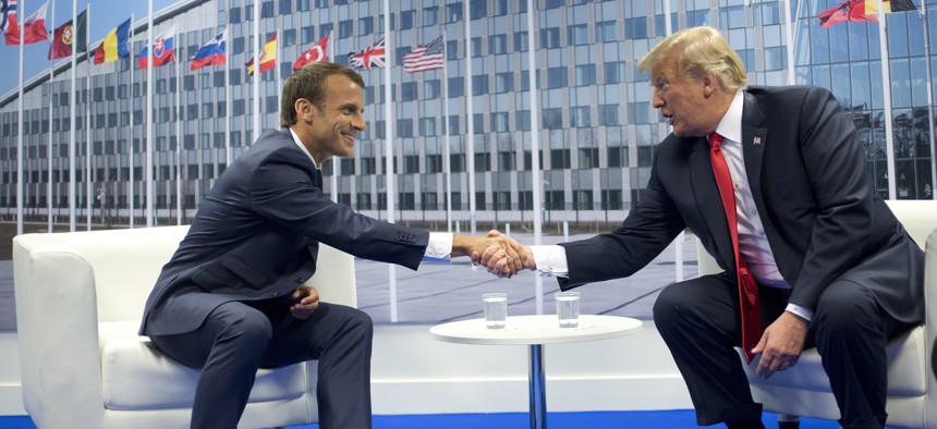 President Donald Trump and French President Emmanuel Macron shake hands during their bilateral meeting, Wednesday, July 11, 2018 in Brussels, Belgium.