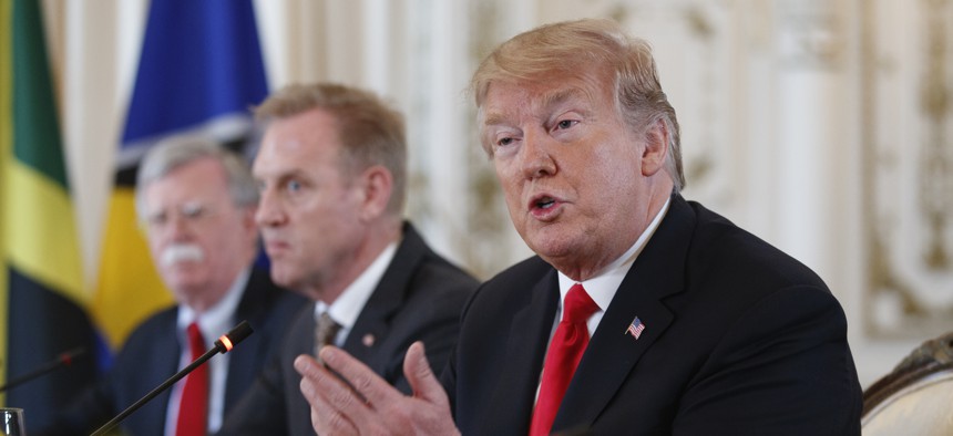 From left, National Security Adviser John Bolton, Acting Defense Secretary Patrick Shanahan, and President Donald Trump sit together during a meeting with Caribbean leaders at Mar-A Lago, Friday, March 22, 2019, in Palm Beach, Fla.