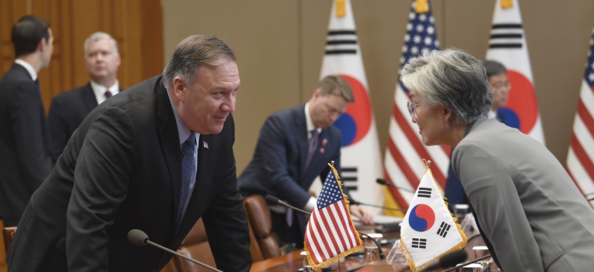 Secretary of State Mike Pompeo, left, talks with South Korean Foreign Minister Kang Kyung-wha before the start of a meeting with President Donald Trump and South Korean President Moon at the Blue House in Seoul, Sunday, June 30, 2019. 