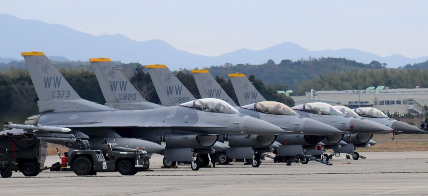 Five F-16 Fighting Falcons are positioned on the flightline at  Japan's Tsuiki Air Base.