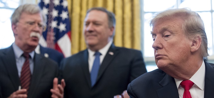 From left, National Security Adviser John Bolton, accompanied by Secretary of State Mike Pompeo, and President Donald Trump, at the White House in Washington, Thursday, Feb. 7, 2019.