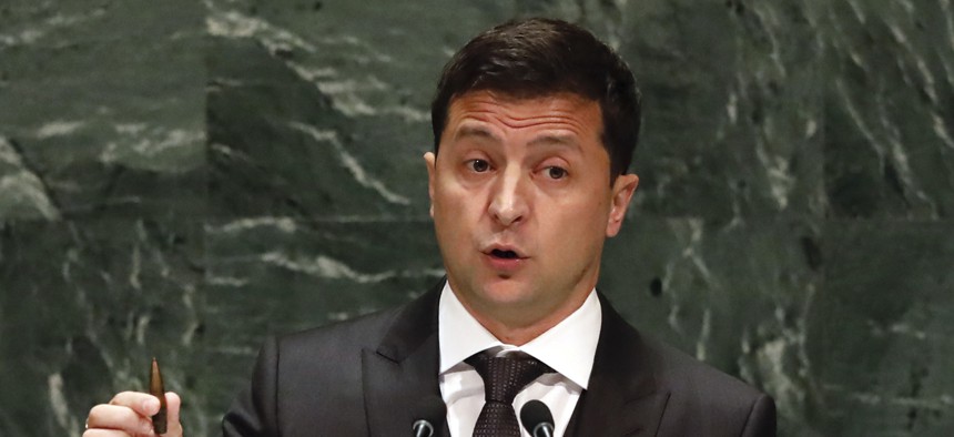 Ukraine's President Volodymyr Zelenskiy holds a bullet as he addresses the 74th session of the United Nations General Assembly, Wednesday, Sept. 25, 2019.
