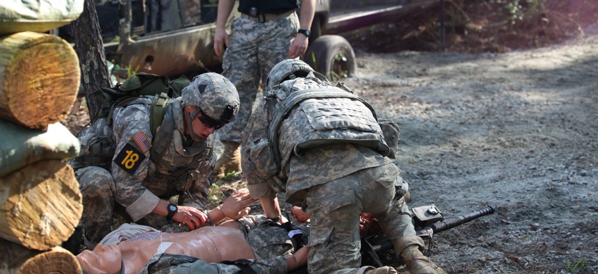 U.S. Army Rangers, 1st Lt. Jonathan Brege and 1st. Lt. Jeffrey Ivas, prepare to evacuate a dummy during the Best Ranger Competition on Fort Benning, Ga., April 12, 2014