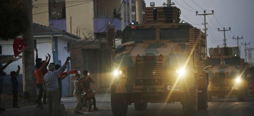 A convoy of Turkish forces vehicles drives through the town of Akcakale, at the border between Turkey and Syria, shortly after Turkey's new ground offensive began, Wednesday, Oct. 9, 2019. 