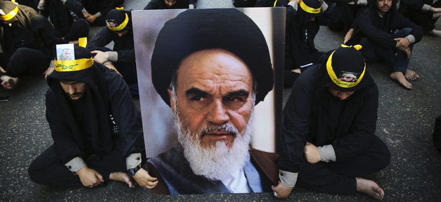 Lebanese supporters of Iran-backed Hezbollah hold a portrait of Iranian supreme leader Ayatollah Ali Khamenei during the holy day of Ashoura in a southern suburb of Beirut, Lebanon, Tuesday, Sept. 10, 2019.
