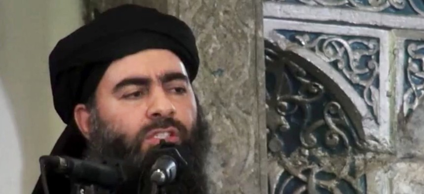 This file image made from video posted on a militant website Saturday, July 5, 2014, purports to show the leader of the Islamic State group, Abu Bakr al-Baghdadi, delivering a sermon at a mosque in Iraq during his first public appearance. 