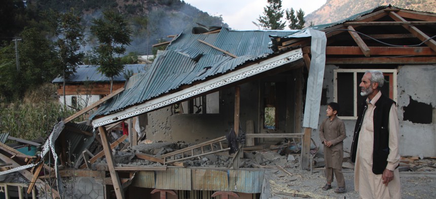 Pakistani Kashmiri residents look at the destruction reportedly caused by artillery fired by Indian forces in Neelum Valley along the Line of Control in Pakistani Kashmir, Monday, Oct. 21, 2019.
