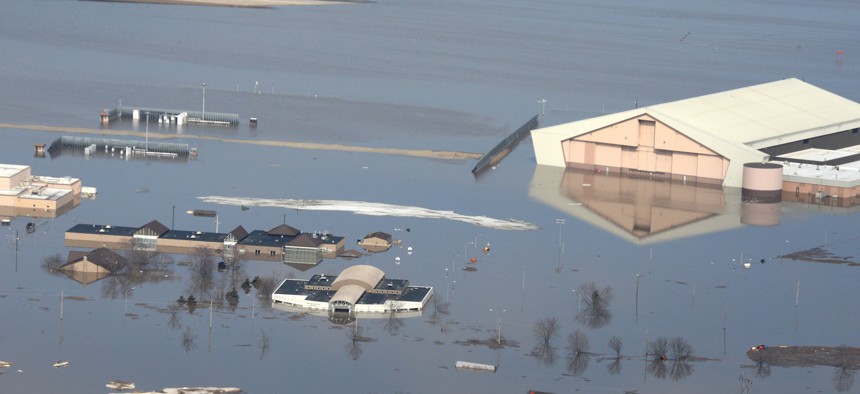 This March 17, 2019 photo released by the U.S. Air Force shows an aerial view of Offutt Air Force Base and the surrounding areas affected by flood waters in Nebraska.