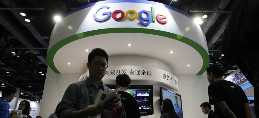  In this April 28, 2016, file photo, visitors gather at a display booth for Google at the 2016 Global Mobile Internet Conference (GMIC) in Beijing. 