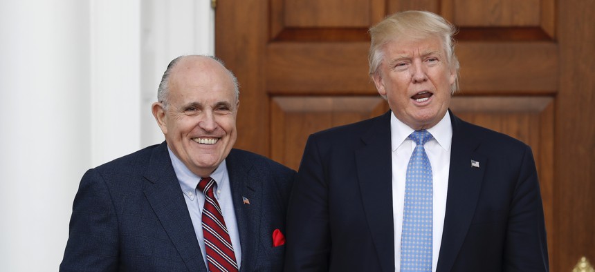 President-elect Donald Trump calls out to media as he and former New York Mayor Rudy Giuliani pose for photographs as Giuliani arrives at the Trump National Golf Club Bedminster clubhouse, Sunday, Nov. 20, 2016, in Bedminster, N.J.