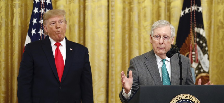President Donald Trump listens as Senate Majority Leader Mitch McConnell of Ky., speaks in the East Room of the White House during an event about Trump's judicial appointments, Wednesday, Nov. 6, 2019, in Washington.