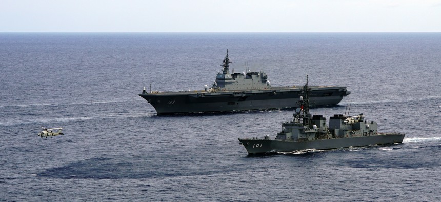 In this June 28, 2019, photo, Japan's Maritime Self-Defense Force helicopter carrier Izumo (DDH-183) and destroyer JS Murasame (DD-101) participate in drills that included maritime navigation and emergency response exercises in Sulu Sea. 