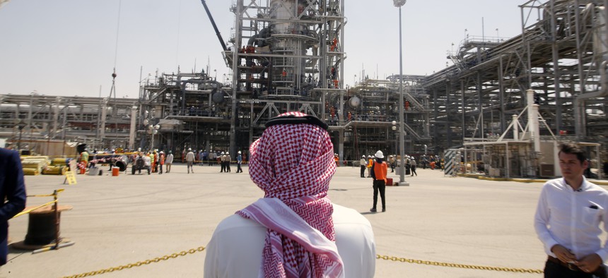 In this photo opportunity during a trip organized by Saudi information ministry, a man stands in front of the Khurais oil field in Khurais, Saudi Arabia, Friday, Sept. 20, 2019, after it was hit during Sept. 14 attack.