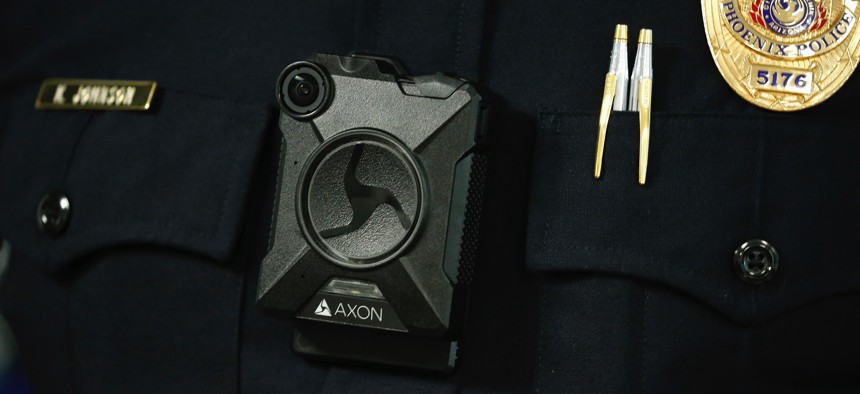 Phoenix Police Department Sgt. Kevin Johnson shows off the new Axon Body 2 body camera as another precinct gets their cameras assigned to them Wednesday, July 3, 2019, in Phoenix. 