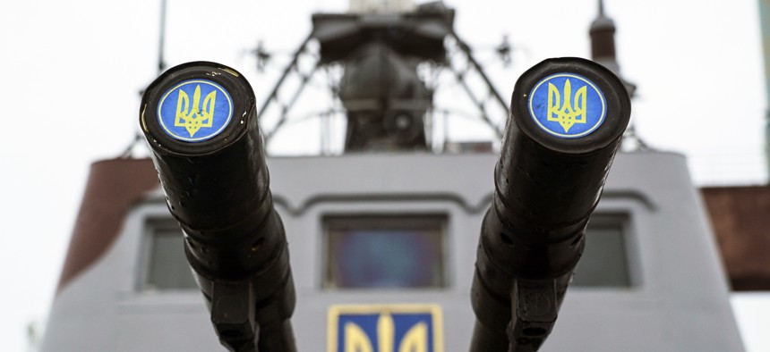 Lids emblazoned with a Ukrainian emblem cover the barrels on a gun mount aboard a Ukrainian coast guard ship in the Sea of Azov port of Mariupol, eastern Ukraine, Monday, Dec. 3, 2018.