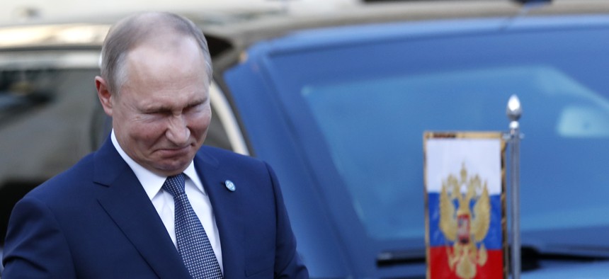 Russian President Vladimir Putin grimaces as he arrives at the Elysee Palace Monday, Dec. 9, 2019 in Paris. 