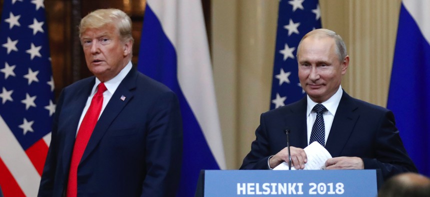 In this July 16, 2018, file photo, U.S. President Donald Trump, left, and Russian President Vladimir Putin arrive for a press conference after their meeting at the Presidential Palace in Helsinki, Finland.