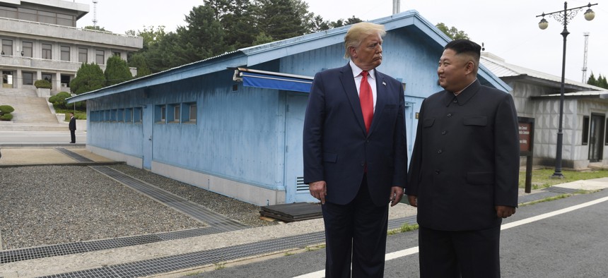 In this June 30, 2019, file photo, U.S. President Donald Trump, left, meets with North Korean leader Kim Jong Un at the border village of Panmunjom in Demilitarized Zone, South Korea. 