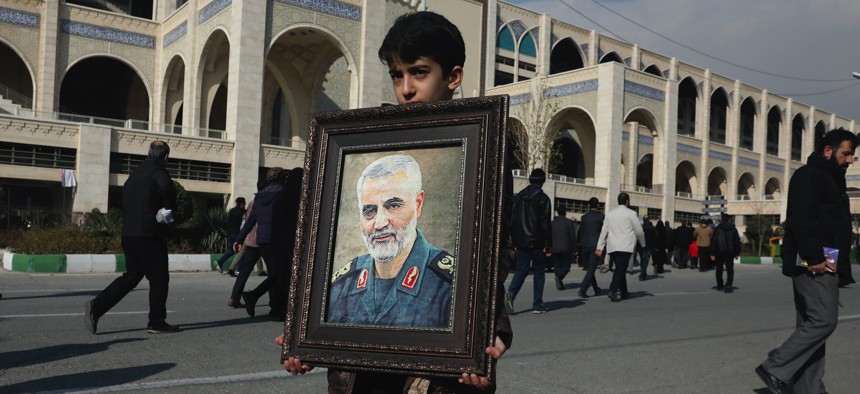 A boy carries a portrait of Iranian Revolutionary Guard Gen. Qassem Soleimani, who was killed in the U.S. airstrike in Iraq, prior to the Friday prayers in Tehran, Iran, Friday Jan. 3, 2020.