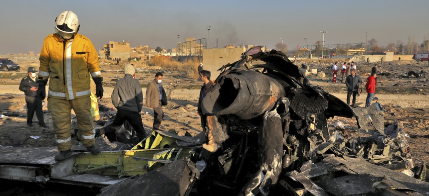 Rescue workers search the scene where a Ukrainian plane crashed in Shahedshahr, southwest of the capital Tehran, Iran, Wednesday, Jan. 8, 2020.