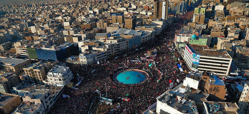 In this aerial photo released by the Iranian government, mourners attend a funeral ceremony for Iranian Gen. Qassem Soleimani and his comrades, who were killed in Iraq in a U.S. drone strike on Friday, in Tehran, Iran, Monday, Jan. 6, 2020. 