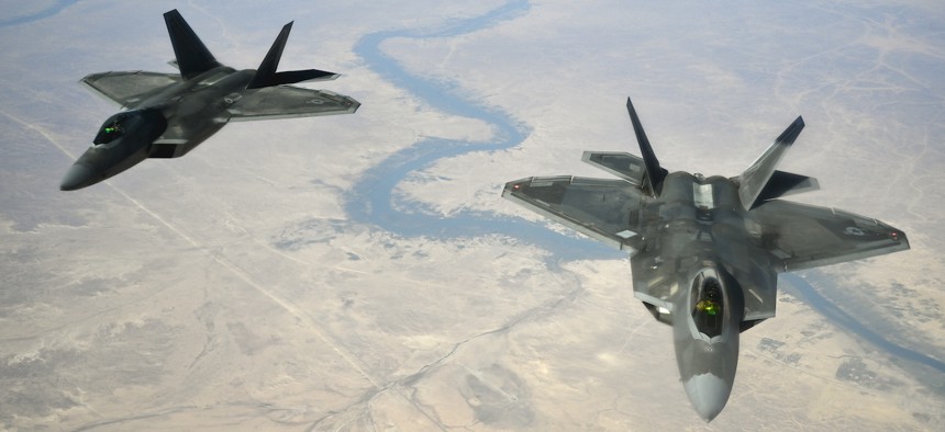 U.S. Air Force F-22 Raptors fly in formation behind a 28th Expeditionary Air Refueling Squadron KC-135 Stratotanker during a combat air patrol mission, Nov. 15, 2019.