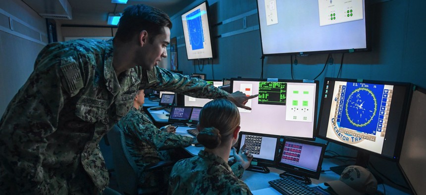 Lt. Aaron Van Driessche, a warfare tactics instructor in San Diego, pilots the U.S. Navy’s virtual combat curriculum aboard USS Paul Hamilton inside the On Demand Trainer, a new portable simulator.