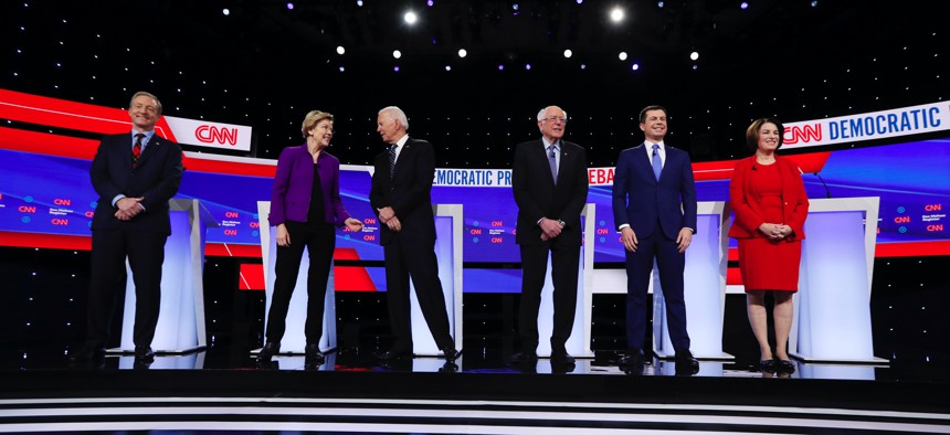 Democratic presidential candidates stand on stage, Tuesday, Jan. 14, 2020, before a Democratic presidential primary debate hosted by CNN and the Des Moines Register in Des Moines, Iowa.