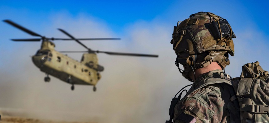 Army Staff Sgt. Jason N. Bobo watches as a CH-47 Chinook prepares to land to provide transport for U.S. and Afghan soldiers after a key leader engagement in southeastern Afghanistan, Dec. 29, 2019.