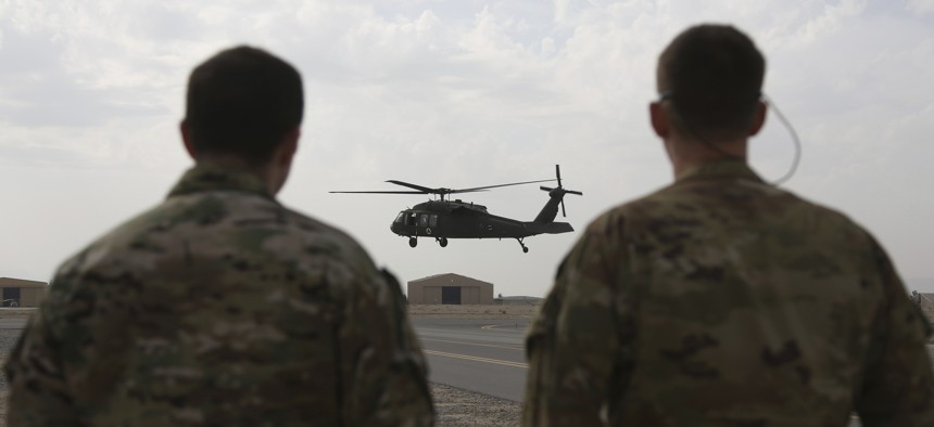 In this Monday, March 19, 2018 photo, a UH-60 Black Hawk helicopter carrying US advisers and Afghan trainees takes off at Kandahar Air Field, Afghanistan.