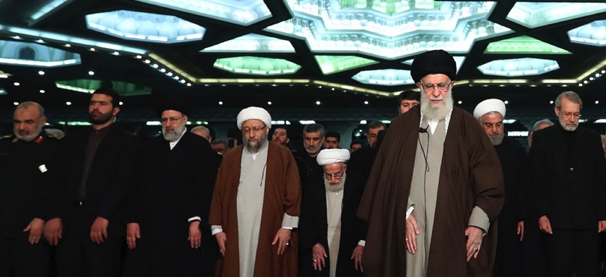 In this photo released by the official website of the office of the Iranian supreme leader, Supreme Leader Ayatollah Ali Khamenei, center, leads the Friday prayers at Imam Khomeini Grand Mosque in Tehran, Iran, Friday, Jan. 17, 2020.